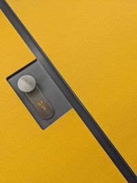 Close-up of mobile phone on yellow background
