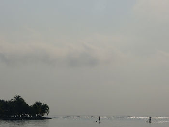 Silhouette boating in calm sea