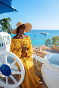 Portrait of beautiful african american model girl in stylish sun hat. fashion black 