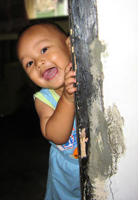 Close-up portrait of smiling boy in water