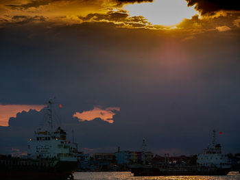 Scenic view of city against sky during sunset