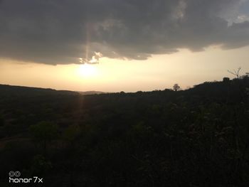 Scenic view of landscape against sky during sunset