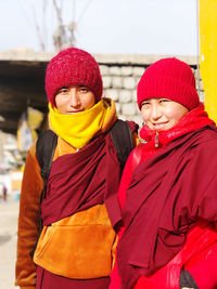 Portrait of a smiling young woman standing in snow