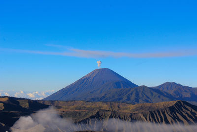 View of volcanic mountain against blue sky