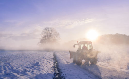 Snowplough in winter landscape