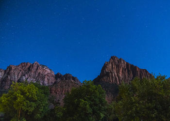 Low angle view of rock formation against sky at night