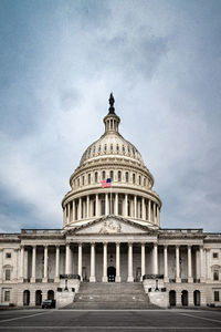 Facade of the united states capitol building in washington, d.c. on a cloudy and moody day. 