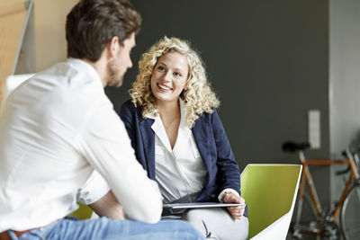 Two colleagues talking in office