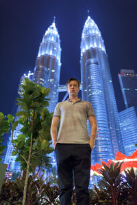 Low angle view of man standing at night