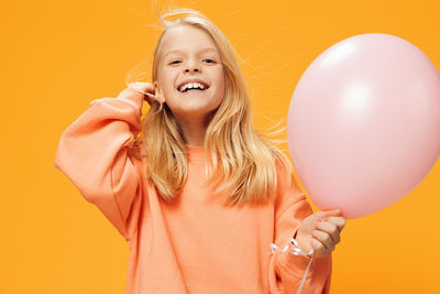 Portrait of young woman with balloons