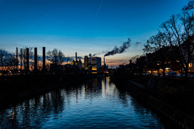 Scenic view of river against blue sky at dusk