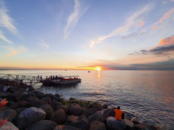 Scenic view of sea against sky at sunset