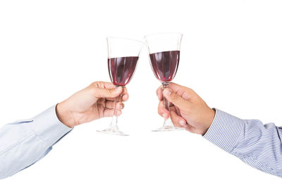 Midsection of man holding drink against white background