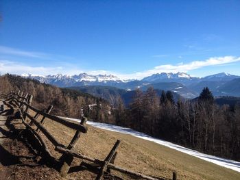 Scenic view of snowcapped mountains against blue sky