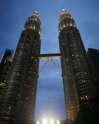 Low angle view of illuminated buildings against sky at night