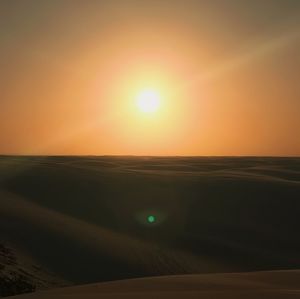 Scenic view of desert against sky during sunset