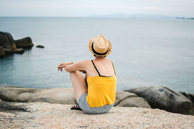 Rear view of woman looking at sea shore