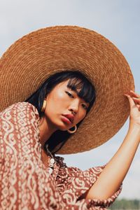 Portrait of beautiful young woman wearing hat