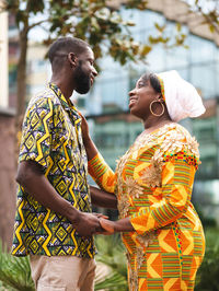 Side view of couple standing outdoors