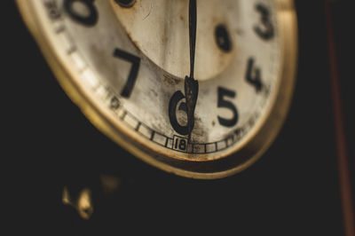 Close-up of clock against black background
