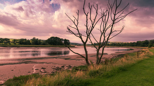 Scenic view of lake against sky during sunset