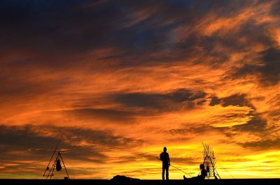 Silhouette of people at sunset