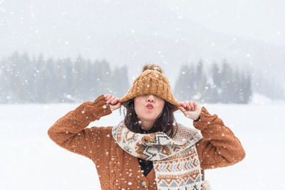 Portrait of a young woman in winter. snowfall, outdoors, happy.