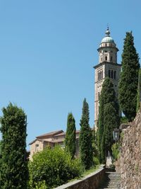 Low angle view of bell tower against clear blue sky