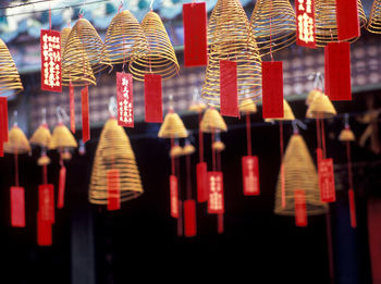 Low angle view of spiral incenses at temple