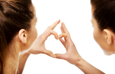 Portrait of woman with hands against white background