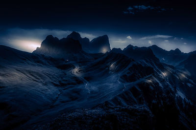 Scenic night view of snowcapped mountains against sky