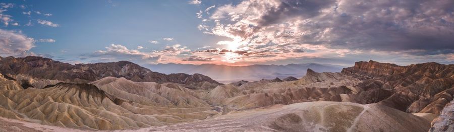 Panoramic view of desert against sky during sunset
