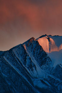 Scenic view of snowcapped mountain against sky during sunset