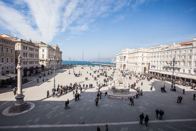 High angle view of people at piazza unita d italia against sky