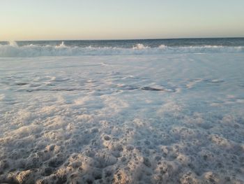 Scenic view of sea against cloudy sky