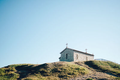 Low angle view of built structure against clear blue sky