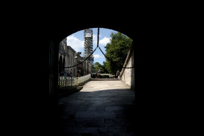 Archway amidst buildings against sky