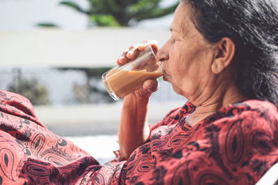 Side view of a woman drinking drink