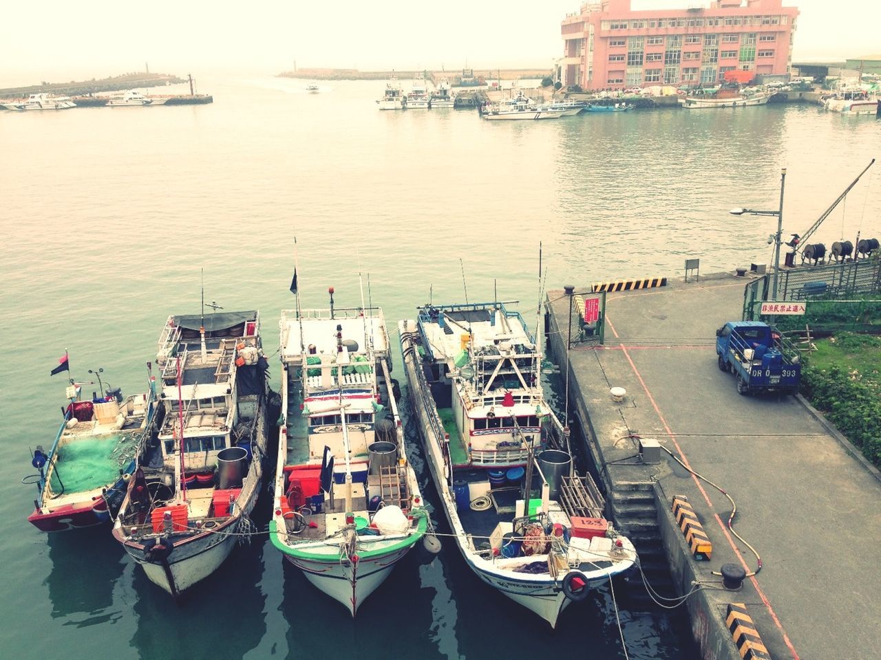 nautical vessel, water, transportation, boat, mode of transport, moored, building exterior, architecture, sea, built structure, harbor, city, high angle view, waterfront, river, travel, day, sky, incidental people, outdoors