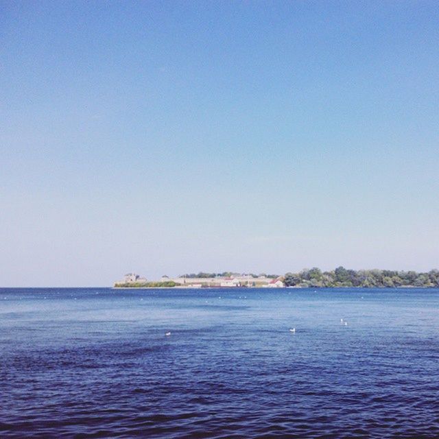 water, clear sky, sea, copy space, waterfront, blue, tranquil scene, tranquility, scenics, beauty in nature, nature, horizon over water, rippled, idyllic, nautical vessel, day, outdoors, beach, calm, remote