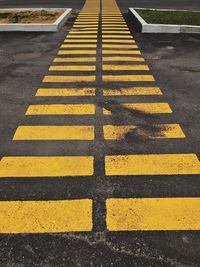 High angle view of yellow crossing sign on road