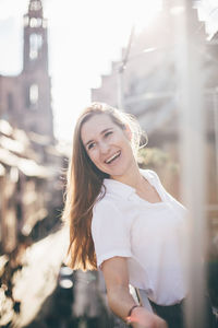 Portrait of smiling young woman standing outdoors