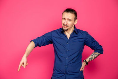 Portrait of man against red background