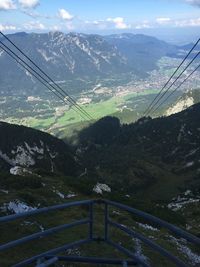 Overhead cable car over mountains against sky
