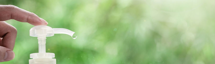 Close-up of hand holding white water