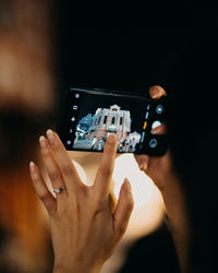 Cropped image of hand holding smart phone