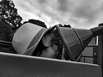 Portrait of girl wearing hat against sky