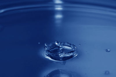 Close-up of water splashing against blue background