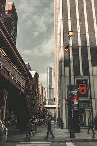 People walking on road against buildings