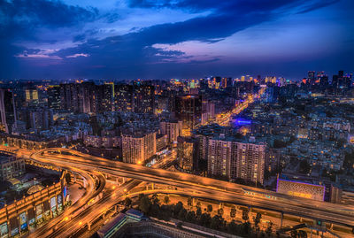 High angle view of illuminated city street against sky at night